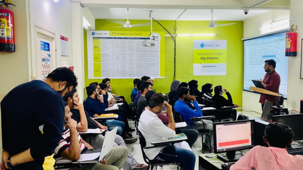 A trainer leading a PTE Academic classroom session