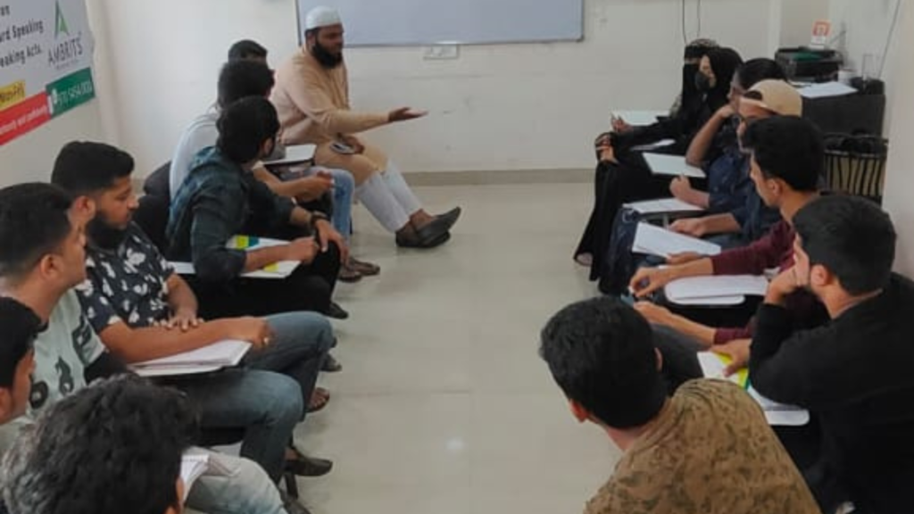 A Spoken English trainer leading a group discussion activity