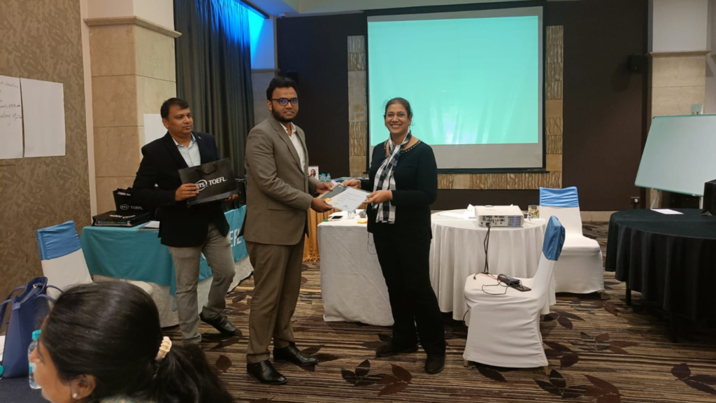 Presenting a certificate at a TOEFL partner event